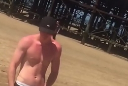 horny shirtless dude adjusts his crumple go on his New Zealand